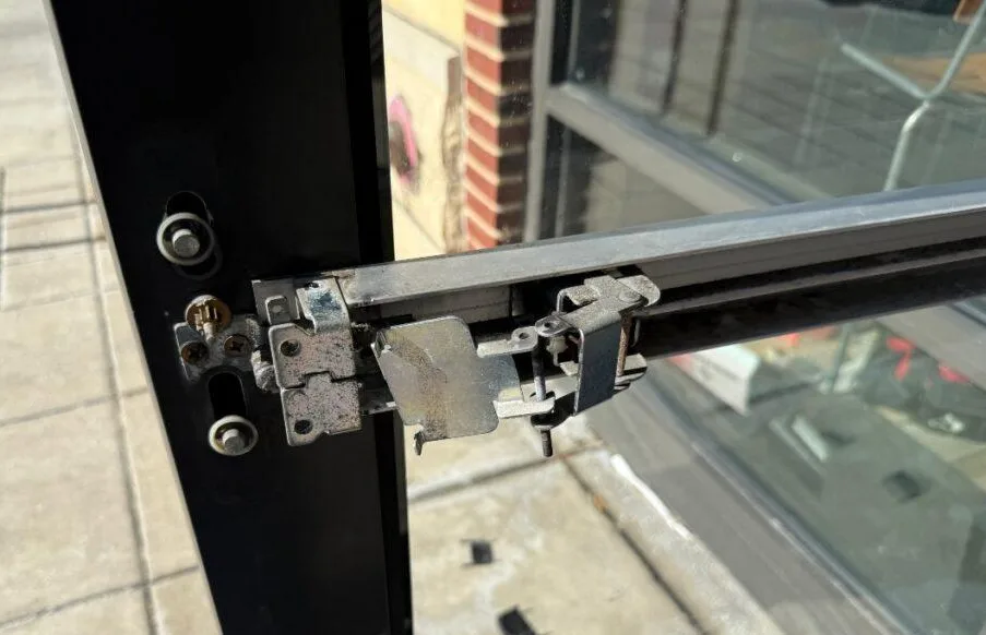 Triton Locksmith repairing commercial door hardware that prevents door from closing
