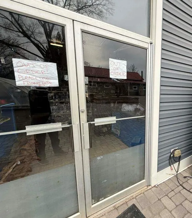 Triton Locksmith adjusting commercial door alignment at office building in South Florida