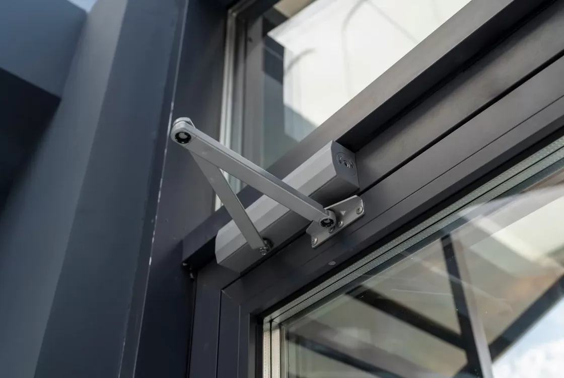 Triton Locksmith installing LCN commercial door closer on office building in South Florida