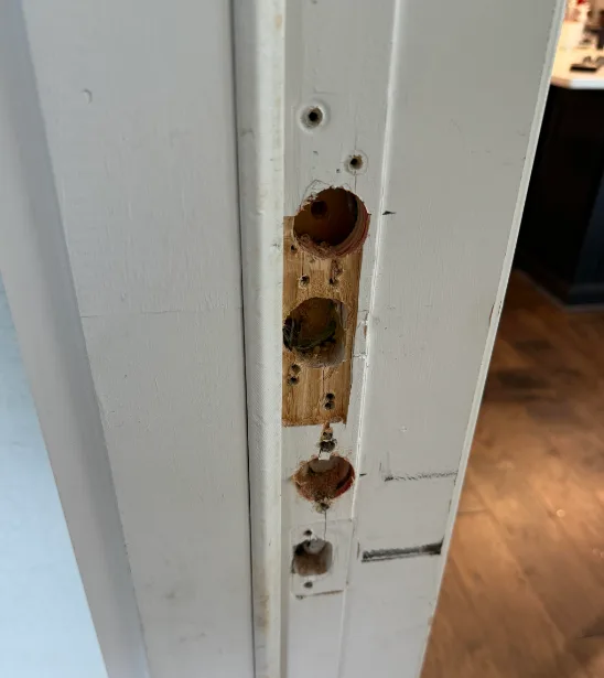 Triton Locksmith repairing damaged commercial hollow metal door frame strike area