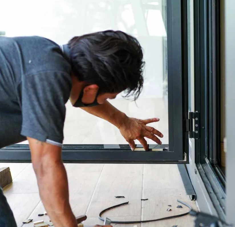 Triton Locksmith repairing commercial glass door patch fitting at retail store in South Florida