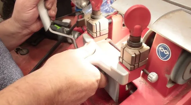 Professional key duplication service cutting house keys on calibrated key machine by Triton Locksmith