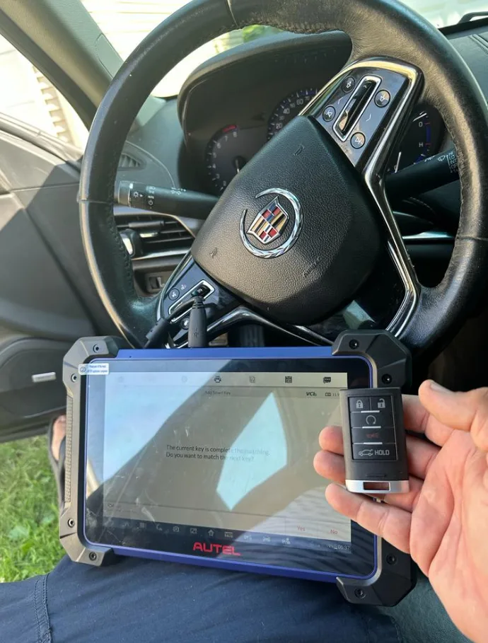 New key fob being programmed to vehicle by Triton Locksmith on site