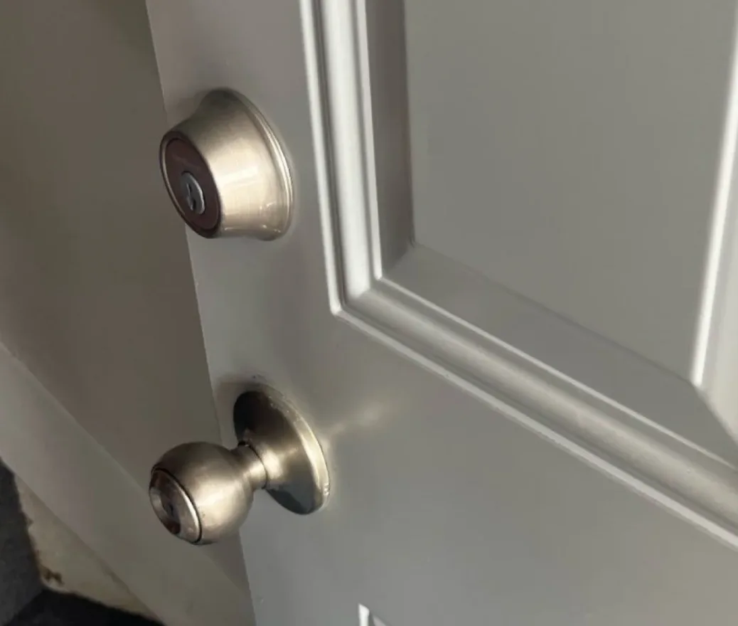 Triton Locksmith performing scheduled commercial lock maintenance on office building doors