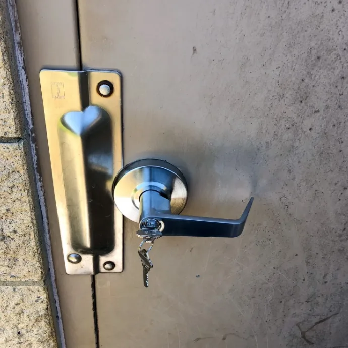 Locksmith picking commercial mortise lock during office lockout at South Florida business