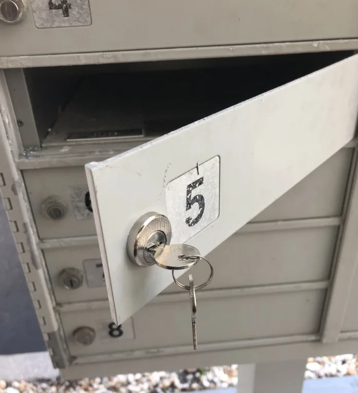 Mailbox lock replacement service by Triton Locksmith replacing broken cam lock with new keys