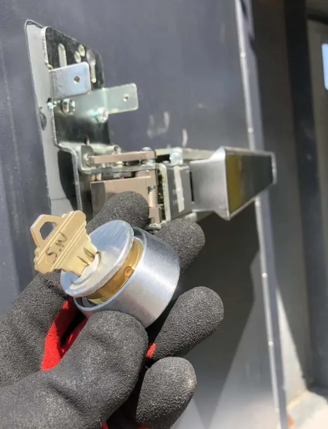 Locksmith rekeying commercial mortise cylinder at office building in South Florida